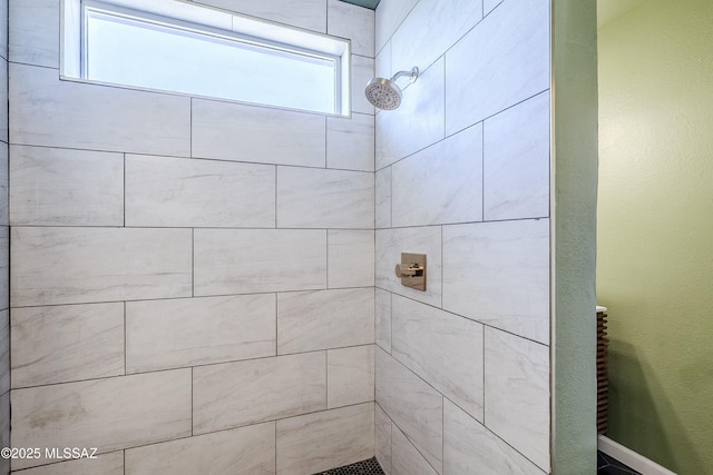 bathroom with a tile shower