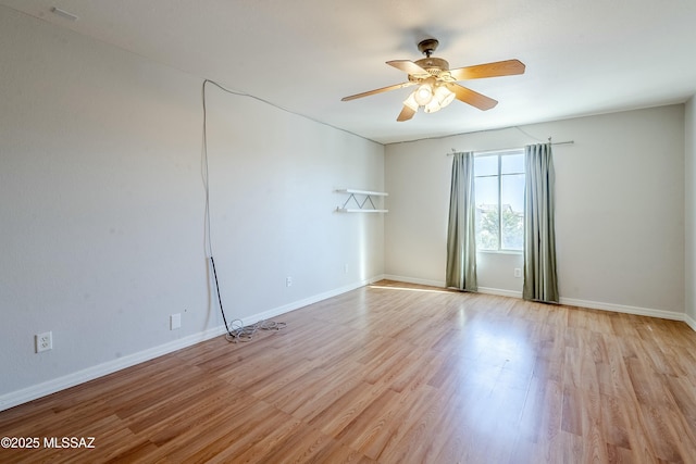 spare room featuring ceiling fan and light hardwood / wood-style floors