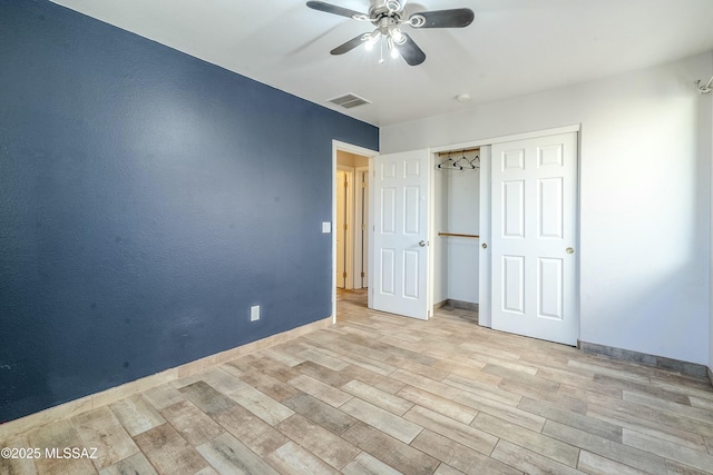 unfurnished bedroom with ceiling fan, a closet, and light hardwood / wood-style flooring