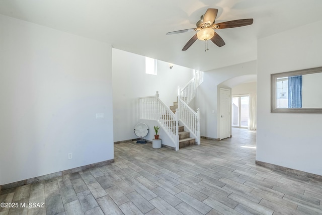 unfurnished living room featuring ceiling fan and light hardwood / wood-style floors