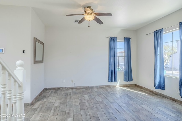 spare room featuring light hardwood / wood-style flooring and ceiling fan