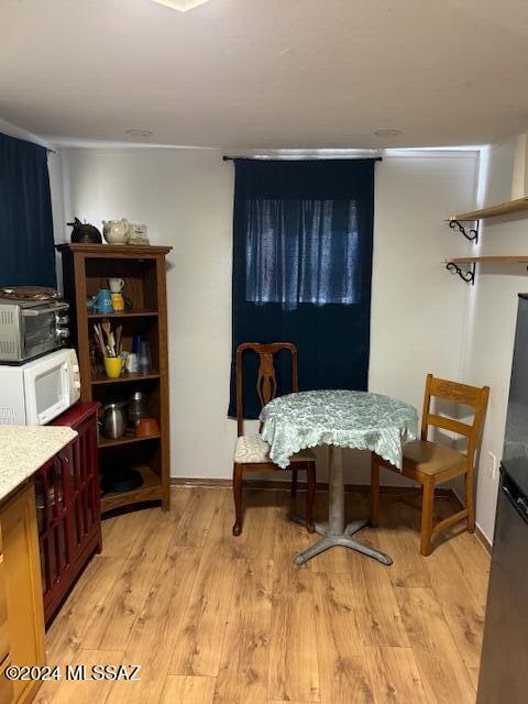 dining space featuring light wood-type flooring