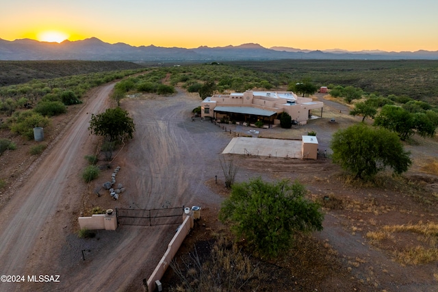 aerial view at dusk featuring a mountain view