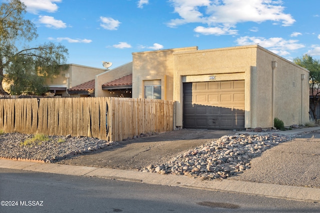 pueblo-style house featuring a garage