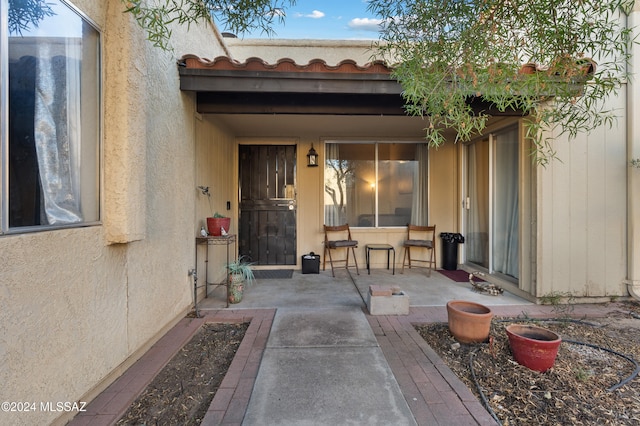 entrance to property featuring a patio area