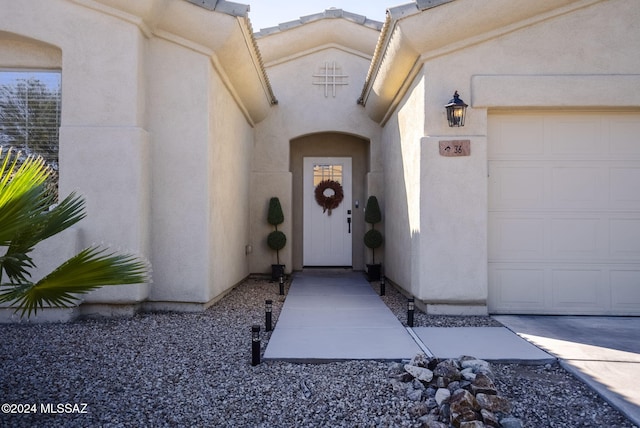 view of exterior entry featuring a garage