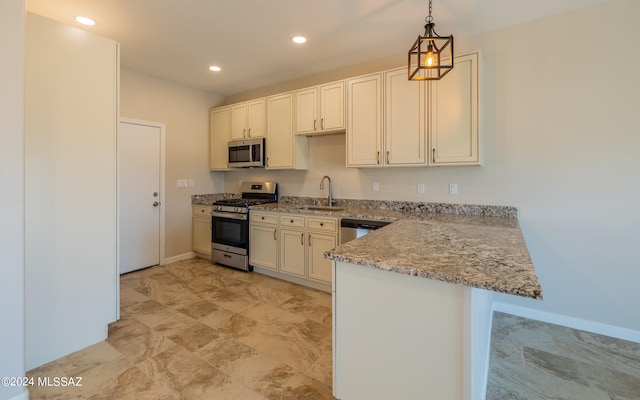 kitchen featuring kitchen peninsula, appliances with stainless steel finishes, light stone countertops, pendant lighting, and sink