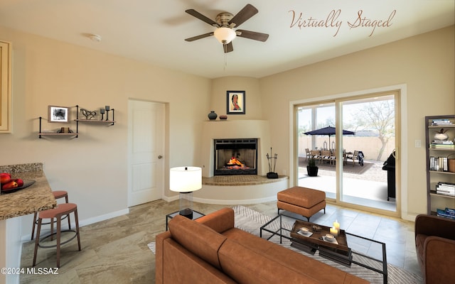 living room featuring a fireplace and ceiling fan