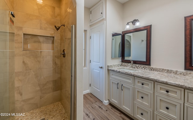 bathroom with vanity, hardwood / wood-style floors, and walk in shower