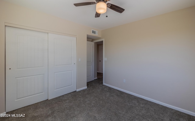 unfurnished bedroom featuring a closet, ceiling fan, and dark carpet