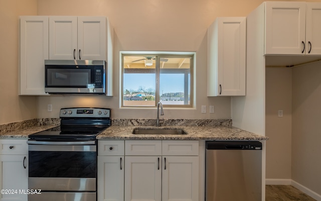 kitchen featuring white cabinetry, stainless steel appliances, and sink