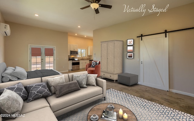 living room featuring a wall unit AC, ceiling fan, light hardwood / wood-style flooring, and a barn door