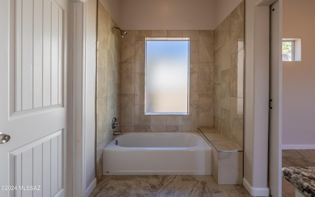 bathroom featuring tiled shower / bath combo