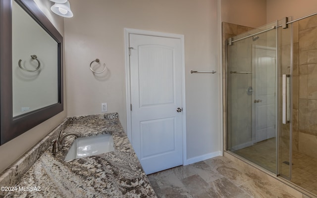 bathroom with vanity and a shower with shower door