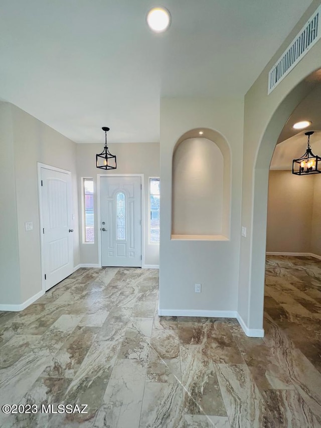 entrance foyer with a chandelier