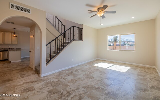 unfurnished living room featuring ceiling fan