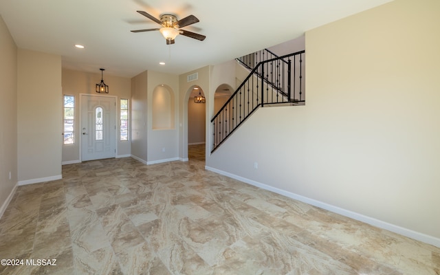 foyer entrance featuring ceiling fan