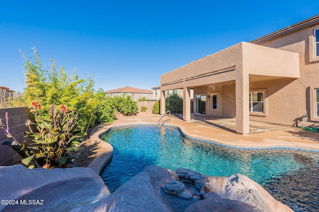 view of swimming pool featuring a patio area, a fenced backyard, and a fenced in pool