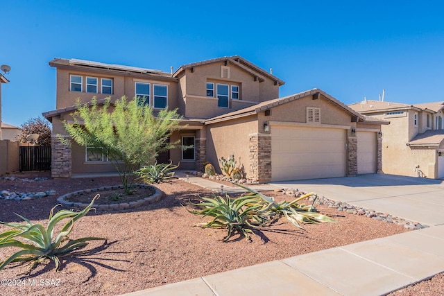 view of front of property featuring a garage, stone siding, concrete driveway, and stucco siding