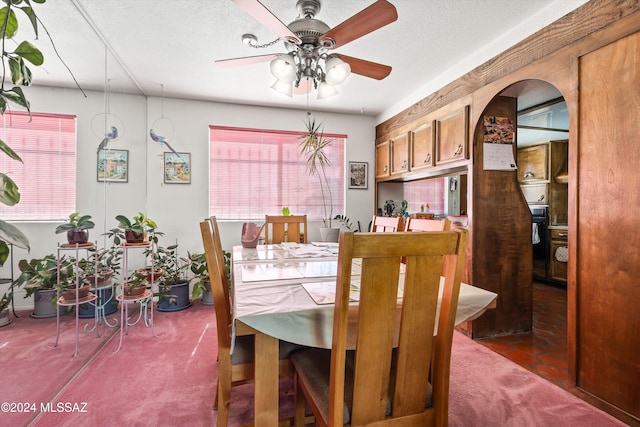 dining area with a textured ceiling, carpet flooring, and ceiling fan