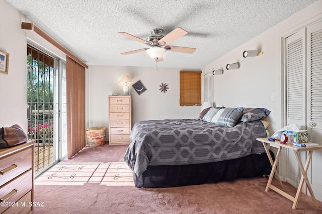 carpeted bedroom featuring access to outside, a textured ceiling, a closet, and ceiling fan