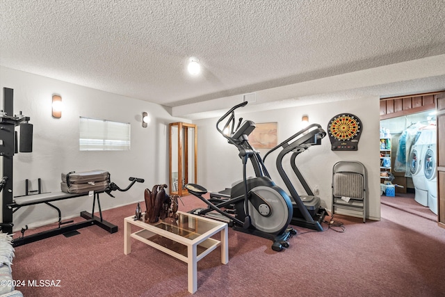 exercise room featuring carpet flooring, washing machine and dryer, and a textured ceiling