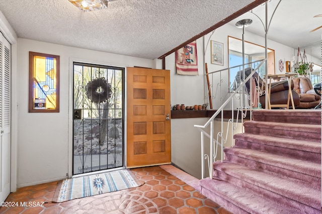 foyer entrance featuring a textured ceiling