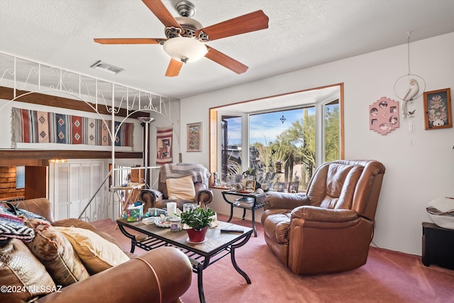 carpeted living room with a textured ceiling and ceiling fan