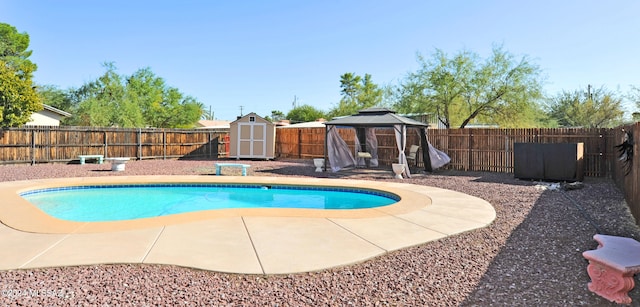 view of pool with a gazebo, a storage shed, and a patio