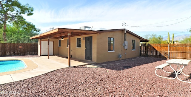 exterior space with a patio area and a fenced in pool