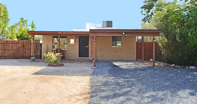 view of front of house featuring a patio and cooling unit