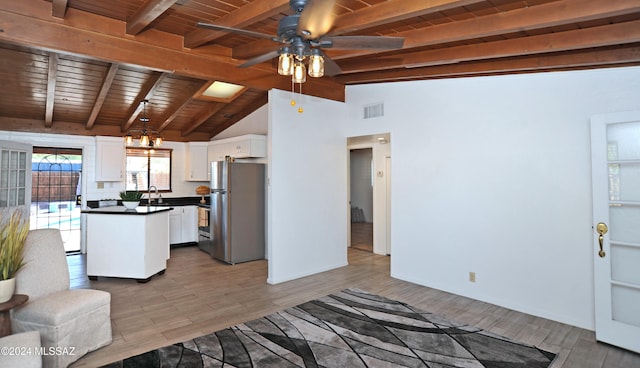 kitchen featuring wood ceiling, stainless steel fridge, white cabinetry, light wood-type flooring, and vaulted ceiling with beams