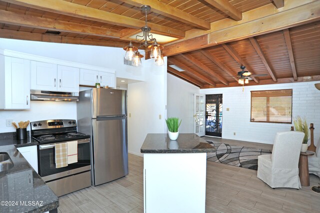 kitchen featuring vaulted ceiling with beams, white cabinetry, stainless steel appliances, wooden ceiling, and brick wall