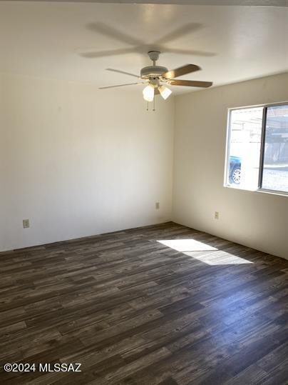 spare room featuring ceiling fan and dark hardwood / wood-style flooring