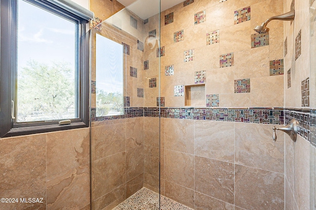 bathroom with tiled shower