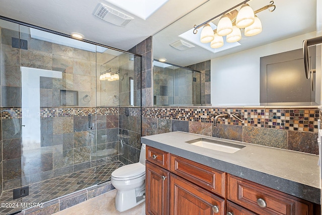 bathroom with tile walls, toilet, vanity, an enclosed shower, and tile patterned floors