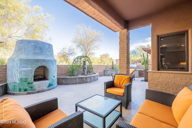 view of patio / terrace featuring grilling area and an outdoor living space with a fireplace