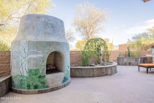 view of patio / terrace with an outdoor fireplace