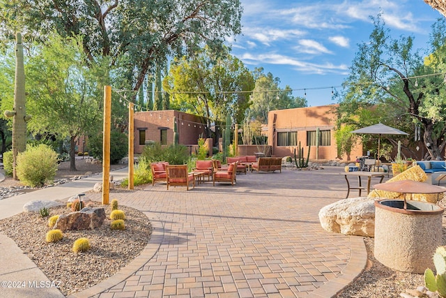 surrounding community with a patio area and an outdoor hangout area