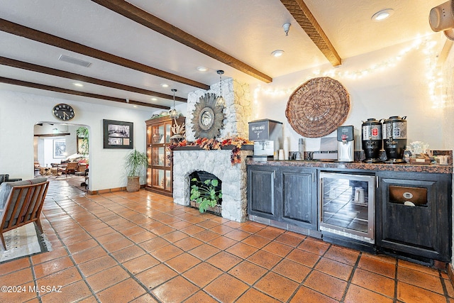 interior space featuring beamed ceiling, bar, a fireplace, and beverage cooler