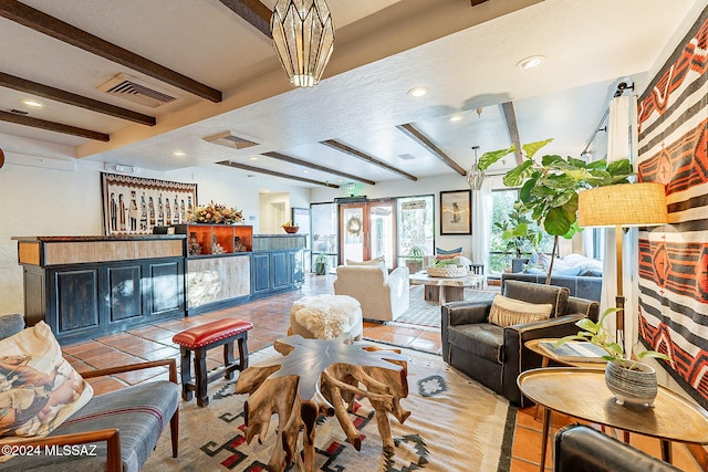 living room featuring a notable chandelier, beamed ceiling, and light tile patterned floors