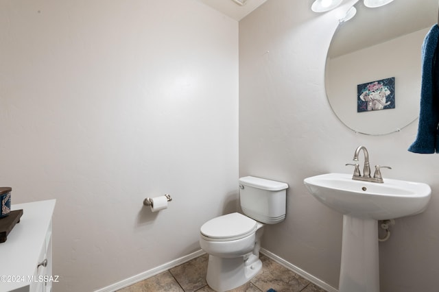 bathroom featuring toilet and tile patterned flooring