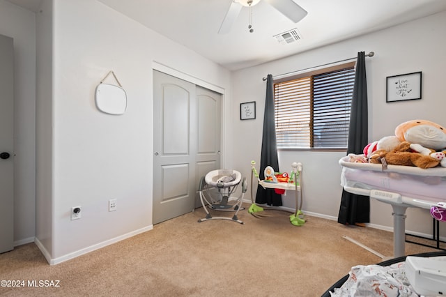 bedroom featuring a closet, light colored carpet, and ceiling fan