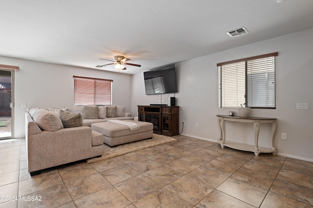 living room with ceiling fan and plenty of natural light