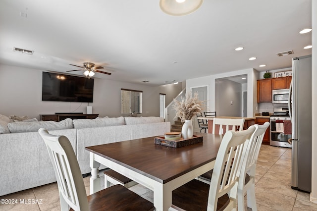 dining area featuring light tile patterned flooring and ceiling fan