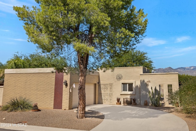 view of front of property with a garage and a mountain view