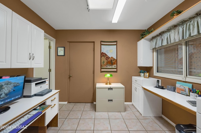 clothes washing area featuring baseboards and light tile patterned floors