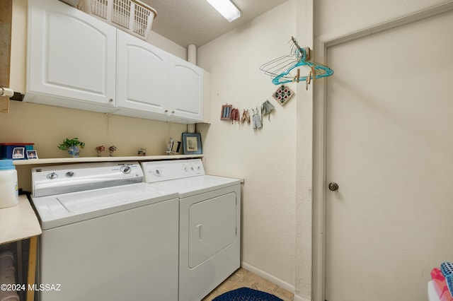 laundry room with cabinet space, light tile patterned floors, and separate washer and dryer