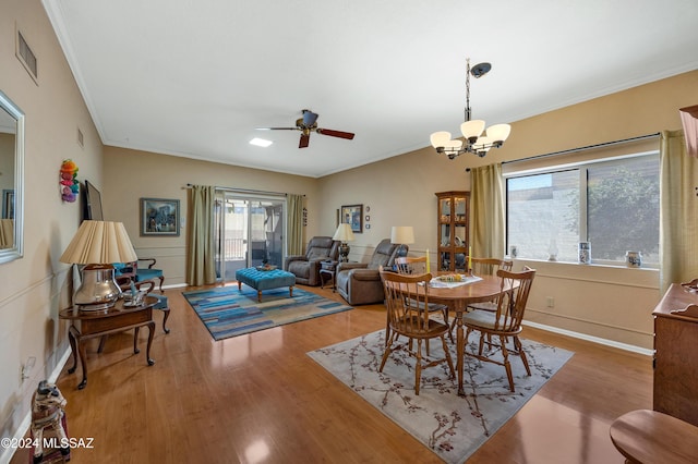 dining room featuring visible vents, crown molding, and wood finished floors