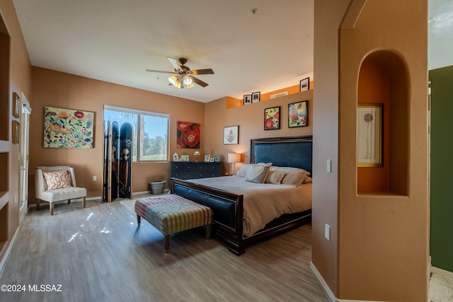 bedroom with wood-type flooring and ceiling fan